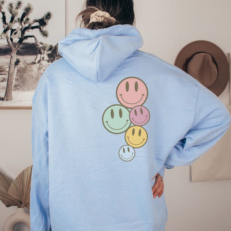 Time for a new Hoodie, and some new vibes! Pastel Smiley Face hooded sweatshirt  On trend, preppy Clean Girl aesthetic hoodie for school, lounging, or walking the beach enjoying the breeze. Exclusively designed by Parcel 23. Direct to garment printed in the USA (this is not a transfer, it's the real deal). Link for T-shirt option: https://www.etsy.com/listing/1548977185/oversized-comfort-colors-have-the-day Select your size and favorite color option, and we'll have it produced and delivered in a Playful Graphic Print Hoodie Sweatshirt, Playful Hoodie With Graphic Print For Spring, Playful Hoodie With Drawstring Hood, Playful Spring Hoodie With Graphic Print, Playful Blue Hoodie For Fall, Playful Graphic Print Hoodie For Spring, Playful Hoodie With Drawstring Hood For Streetwear, Playful Blue Hoodie With Long Sleeves, Playful Blue Hoodie Top