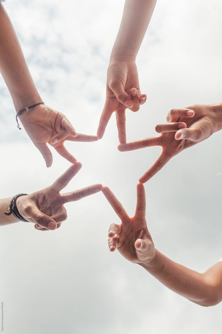 several people holding their hands together in the shape of a star by lumina for stocks