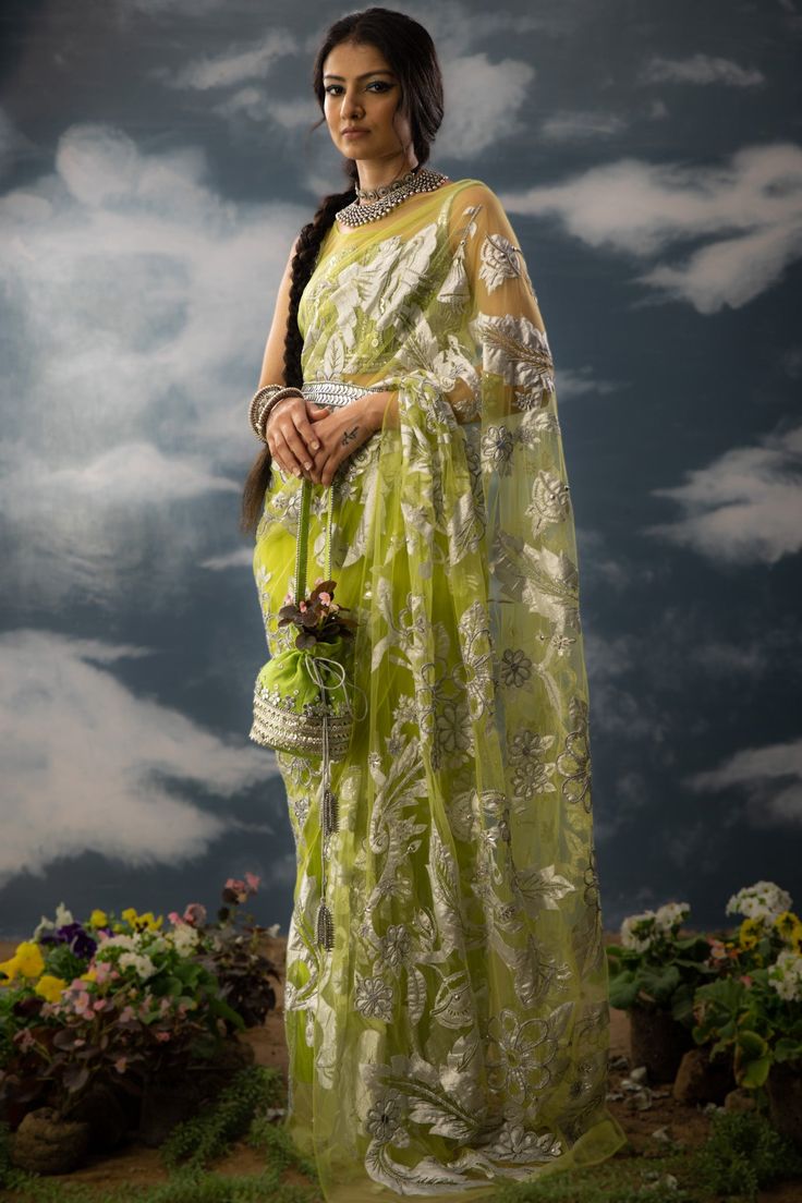 Editor's Note A green patchwork sari in sheer net fabric, it is fully adorned with floral jaal patchwork, aari work and zardozi. The sari comes with a green embroidered blouse handcrafted in chanderi, cotton zari with patchwork and metallic silver. Note: Potli and belt is for styling purposes. Color: Green Fabric: Glass nylon Component: Sari and blouse Occasion: Haldi mehndi and Wedding Guest Care: Dry Clean Only About the Designer Saksham & Neharicka make modernising Indian wear with rich handw Organza Blouse Piece With Pallu In Green, Green Organza Blouse Piece With Pallu, Green Embroidered Pre-draped Saree, Transitional Green Saree With Sheer Dupatta, Festive Organza Blouse Piece For Transitional Season, Festive Transitional Organza Blouse Piece, Green Chikankari Pre-draped Saree For Diwali, Traditional Pista Green Organza Pre-draped Saree, Green Pre-draped Saree With Sheer Dupatta For Navratri