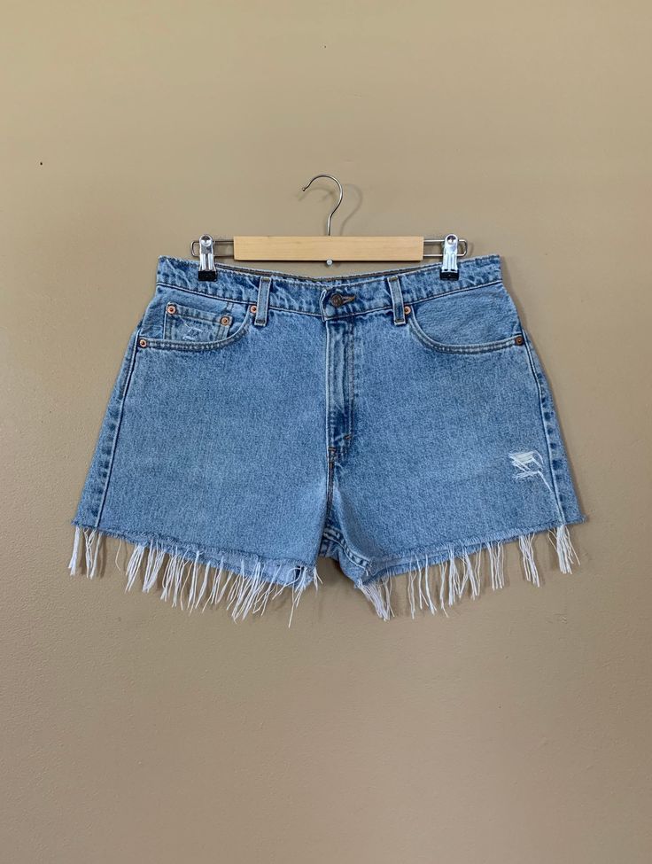 "High waisted 90's denim shorts. Made by Levi's Jeans in light blue denim wash. Shorts are in excellent clean condition. Perfectly worn in with light naturally distressed character and handmade wear holes. These have been cut off and washed once. Measurements are taken zipped or buttoned up and laid comfortably flat then x 2 for total circumference (inches) Tag Size 13 Levis 555 100% Cotton Made in USA Waist 34\" Hips 46\" Length 14\" Inseam 3\" Rise 12\" leg opening circumference 26\" All items Levis Jeans High Waisted, Levi High Waisted Shorts, Levis Mom Jeans, Levis Shorts, 90s Levis, High Waisted Denim Shorts, 90s Denim, Cutoff Shorts, Levi Shorts