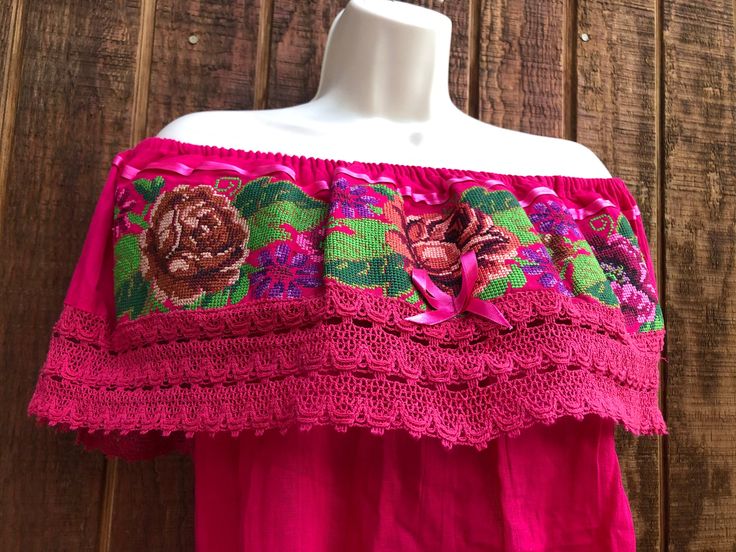 A beautiful, summer festive blouse with floral design. Off the shoulder with short sleeves.  Small-large. Good vintage condition! Measurements taken across front laid flat Bust23" Shoulder to hem23" Waist23" Bohemian Blouse With Woven Motifs For Festivals, Folk Style Short Sleeve Peasant Top With Embroidered Border, Folk Style Peasant Top With Embroidered Border, Pink Short Sleeve Peasant Top For Summer, Summer Festival Off-shoulder Blouse, Festival Blouse With Woven Motifs, Summer Festive Blouse With Floral Embroidery, Summer Festival Blouse With Woven Motifs, Festive Bohemian Tops With Woven Motifs