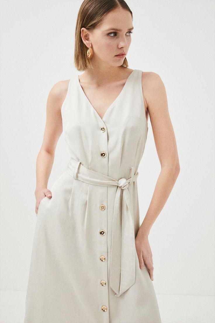 {@@=Ist.Core.Helpers.StringHelper.ToProperCase("With a simple but feminine feel, this light linen-mix midi dress was made for sun-soaked sojourns. It shows off a neat row of glossy buttons, waist-cinching belt and V-neckline to show a hint of skin. Draping elegantly to a mid-calf length, seductive hem splits provide a sense of light airiness whilst practical slip pockets frame the sides for a subtle utilitarian feel.Expertly designed for those 5'3" and under, our Petite pieces are perfectly prop Summer Button-up Belted Dress With Buttons, Spring Knee-length Belted Dress With Buttons, Spring Midi Dress With Tie Fastening, Chic Knee-length Midi Dress With Tie Fastening, Linen Midi Dress For Day Out, Chic Button-up Linen Dress, Spring Midi-length Belted Dress With Tie Fastening, Casual Midi Length Belted Dress With Buttons, Casual Belted Midi Dress With Buttons