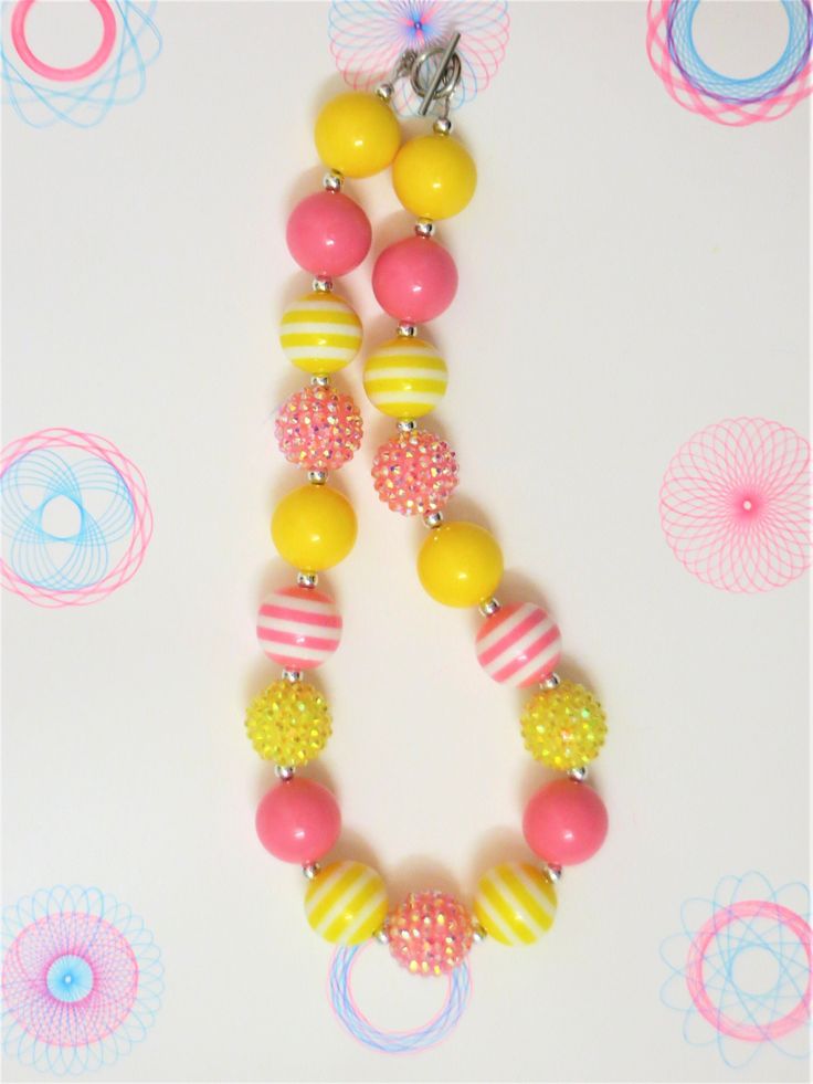 "-  Pink, and yellow chunky beads with silver spacer and sparkle beads -  Your little girl or toddler will look like a Princess in this beautiful, fun, Chunky Bubblegum Necklace. -  This necklace would be the perfect dazzling addition for your little Princess outfit to wear for any special occasion. -  Necklace length 17\"  Materials:  acrylic beads, resin beads, bead wire, crimp tubes, jump rings, stainless steel clasps **Custom Orders Are Welcome** Ready to ship in 1 to 3 business days by USPS First Class Mail. - Returns & Exchanges I do accept returns and exchanges.  Just mail it back to me within 7 days of delivery. WARNING The jewelry is made with small beads and small parts.   Please do not leave your child unattended while wearing the jewelry.  By purchasing the jewelry you are agre Cute Yellow Round Bead Necklaces, Playful Yellow Necklaces With Colorful Beads, Cute Adjustable Yellow Necklace, Cute Adjustable Yellow Necklaces, Fun Yellow Jewelry For Birthday, Playful Round Beads Necklaces For Parties, Cute Beaded Necklaces For Birthday, Cute Round Beads Necklace For Birthday, Playful Yellow Beaded Necklaces