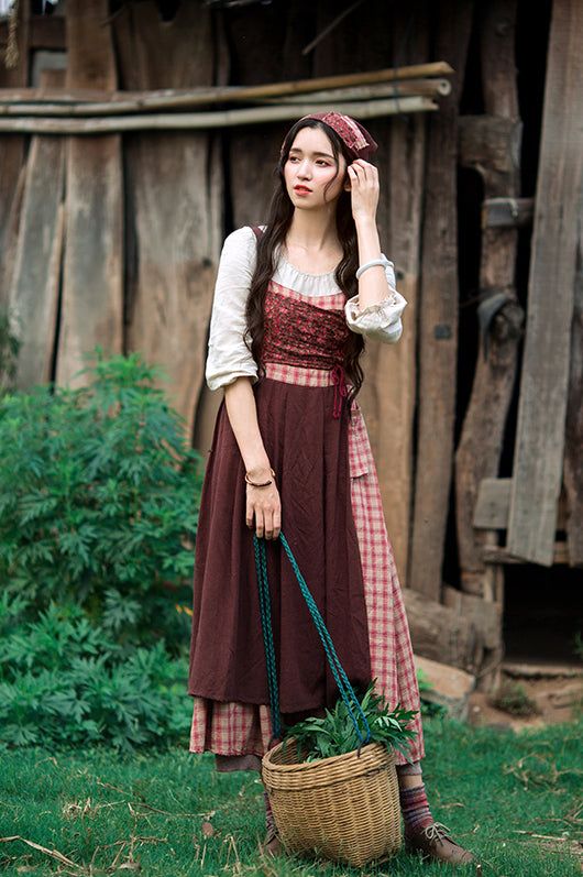 Early 19th century inspired village dress for everyday chores. This faux multi-layered dress features a white blouse part with a scoop neckline and three-quarter blouson sleeves, and a pinafore dress with plaid and ditsy floral patchwork layers. We've deliberately designed the floral patchwork to slant towards one side and attached it with an adjustable lace-up. There's a little pocket dangling at the waist to keep your phone or other knick-knacks. Full knit plaid skirt and partial linen brown skirt to give it a layered apron look. Concealed side zipper. Matching headscarf included. We recommend sizing up for easier wearing and removing. S: 14" across shoulders, 33" chest, 25" waist, 46" lengthM: 14.5" across shoulders, 34.5" chest, 26.5" waist, 46" lengthL: 15" across shoulders, 36" chest Layered Apron, Village Dress, Knit Plaid, Dress For Everyday, Village Girl, Brown Skirt, Interactive Stories, Floral Patchwork, Layered Dress