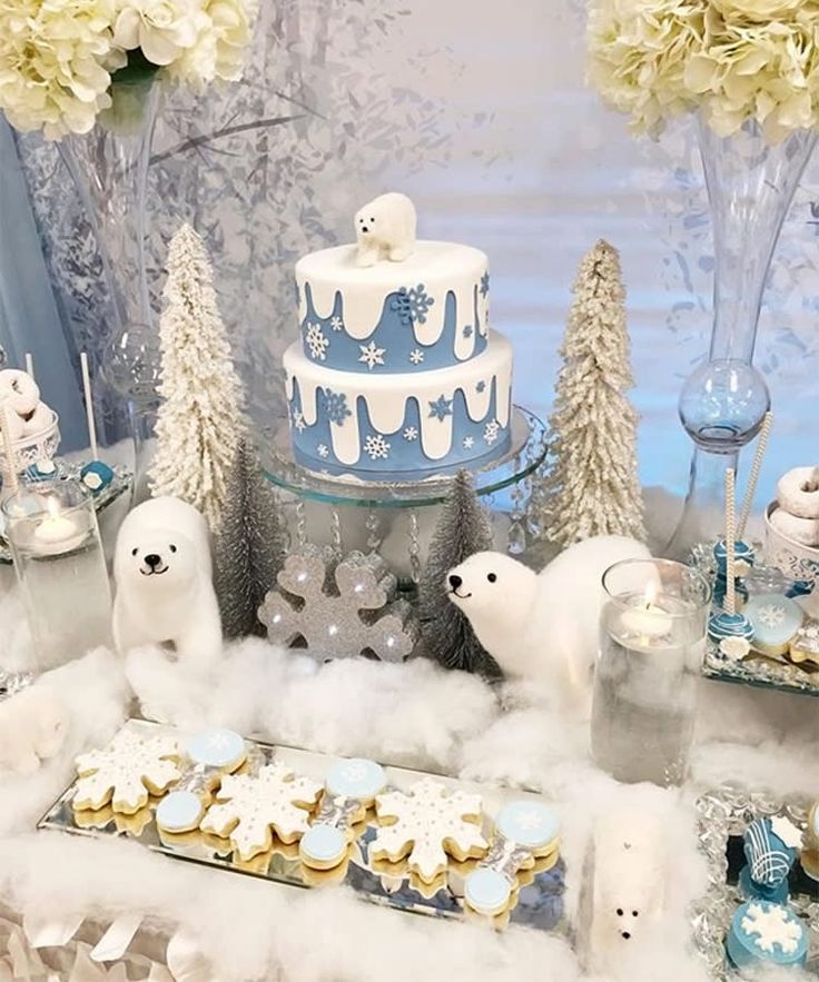 a table topped with lots of cakes and desserts covered in frosted icing