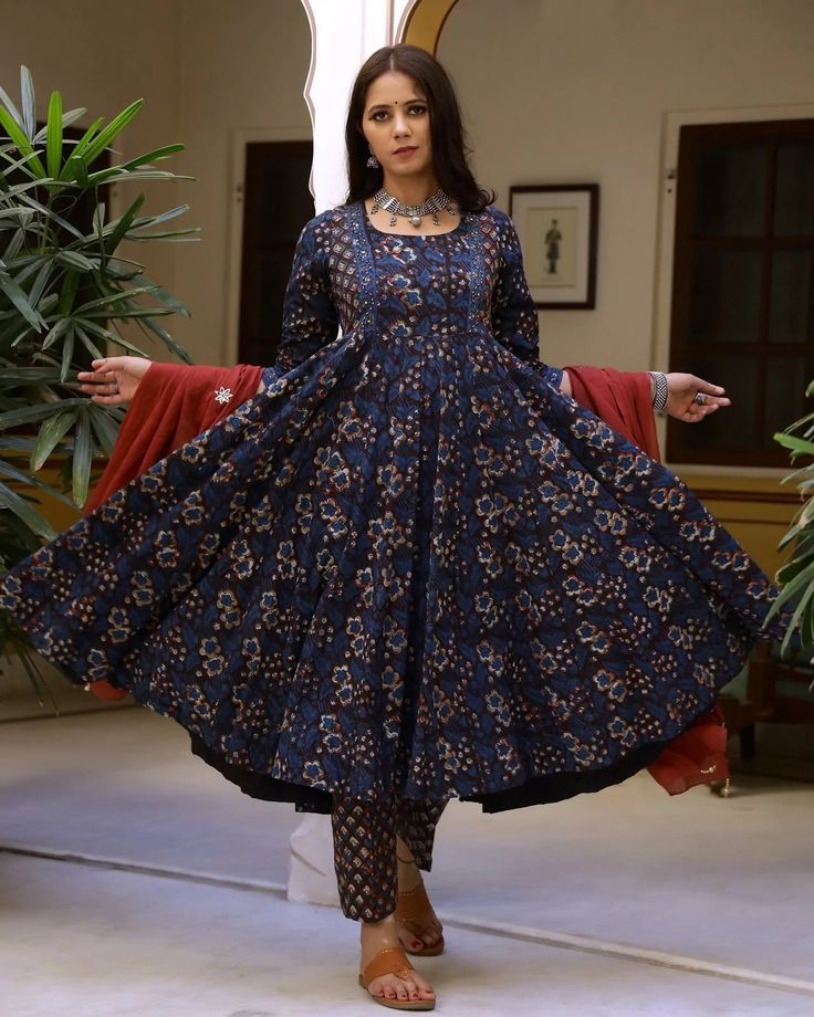 This is a an easy & breezy perfect-for-spring 3 piece suit set. It comes with a 3/4th sleeves bagru print kurta with 32 kali & matching border on the hem and sequence detailing on the neck teamed with printed pants with semi elasticated waistband and a mulmul dupatta with gota work and tassels on the edges. 3 piece set Color- Blue & Red Work-Bagru Print on suit set and embroidery, zari & tassels detailing on dupatta Set Fabric-Cotton Dupatta Fabric-Mulmul Sleeves-3/4th Sleeves Neck-Round Neck Le Festive Indigo Anarkali Set, Designer Indigo Cotton Sets, Blue Fitted Anarkali Set With Floral Print, Fitted Blue Floral Anarkali Set, Designer Blue Kurta With Kalamkari Print, Blue Cotton Anarkali Set With Floral Print, Fitted Indigo Kurta For Navratri, Anarkali Blue Lawn Suit With Block Print, Blue Anarkali Lawn Suit With Block Print