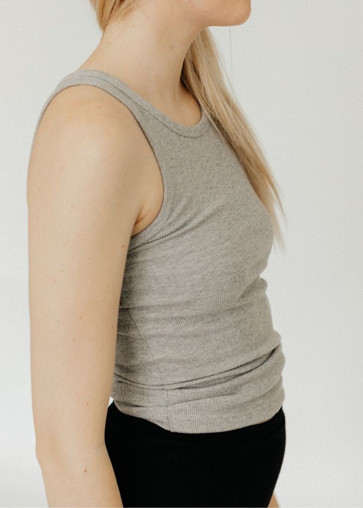 Éterne High Neck Fitted Tank in Heather Grey. Made from a lightweight cotton rib fabric, this tank is both form-fitting and flattering with its high crew neck cut. Perfect for everyday wear, pair it with high-rise jeans or leather pants for a stylish look. Fits true to size, designed for a slim fit Available in Heather Grey 47% cotton, 47% rayon, 6% spandex Machine wash cold. Non-chlorine bleach. Tumble dry low. Cool iron. Do not dry clean. Shop more women's designer leisurewear here. ABOUT ÉTER Chloe Bartoli, Fall Outerwear, Rib Fabric, Designer Tops, Tops Online, Sweater Sale, Video New, Online Tops, Clothing Boutique