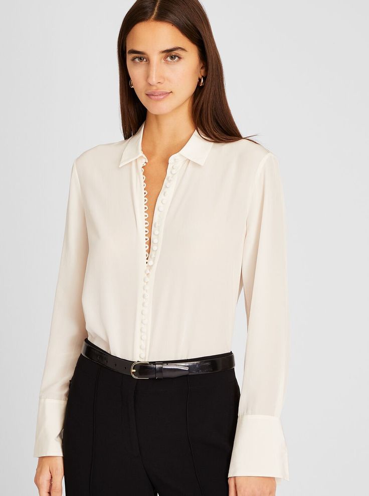 Detail oriented. Split cuffs and self-covered buttons add style to the luxe silk crêpe de Chine Helek shirt. The perfect top to dress up your off-hours denim. Chic Semi-formal Blouse With Hidden Button Closure, Elegant Tops With Button Closure, Elegant Silk Shirt For Workwear, Elegant Silk Shirt For Work, Elegant Spread Collar Blouse For Fall, Elegant Blouse With Fold Down Collar For Office, Elegant Tops With Buttons And Fold Down Collar, Elegant Tops With Buttons And Spread Collar, Elegant Blouse With Spread Collar For Fall