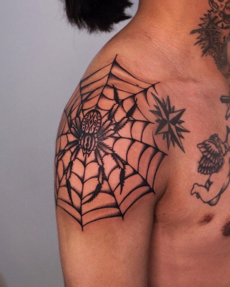 a man with a spider web tattoo on his shoulder