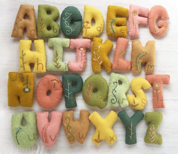 the letters are made out of felt and have leaves on them