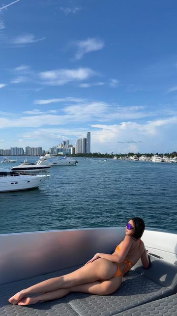 a woman laying on the back of a boat