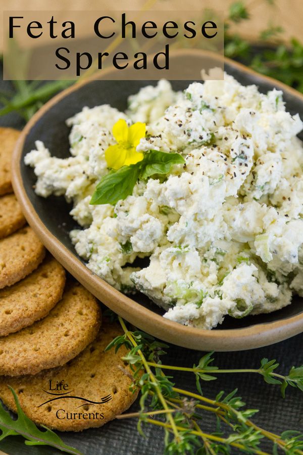 a bowl filled with cottage cheese next to crackers