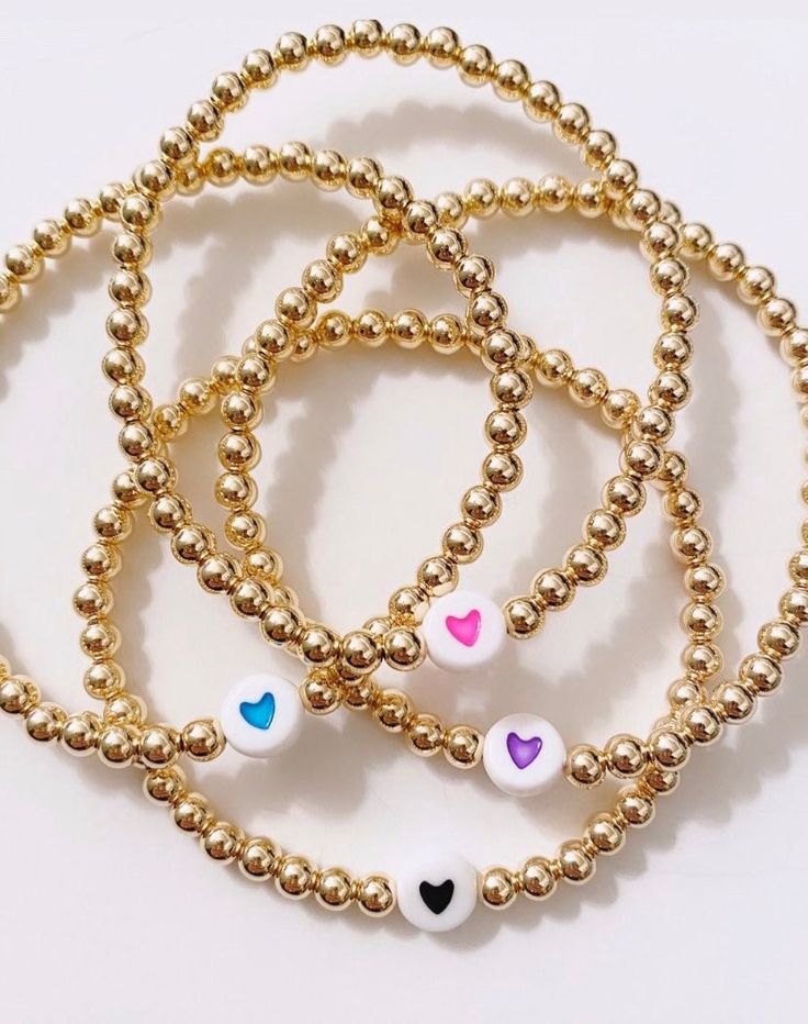 This listing is for one 4mm 14k gold filled beaded bracelet with heart bead. Gold filled beads do not tarnish or peel. Bracelet is light weigh and is stretchy. To measure your wrist, measure snug and add 1/2 inch in order for the bracelet to fit comfortably. Heart comes in your choice of color to select from the drop down menu. Most orders ship within one week, but they can take up to two weeks to ship. Please familiarize yourself with my shop policies before purchasing. Cheap Everyday Heart Beads Bracelets, Dainty Beaded Heart Bracelet With Round Beads, Dainty Heart Bracelet With Round Beads For Friendship, Dainty Heart Charm Bracelet With Round Beads, Everyday Heart-shaped Jewelry With Tiny Beads, Dainty Beaded Bracelets With Heart Charm For Friendship, Dainty Bracelet With Heart Charm And Round Beads, Dainty Jewelry With Heart Shaped Round Beads, Dainty Jewelry With Round Heart Beads