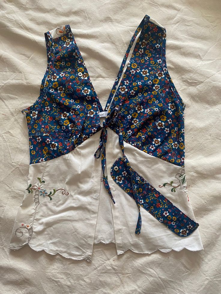 a blue and white top with flowers on it