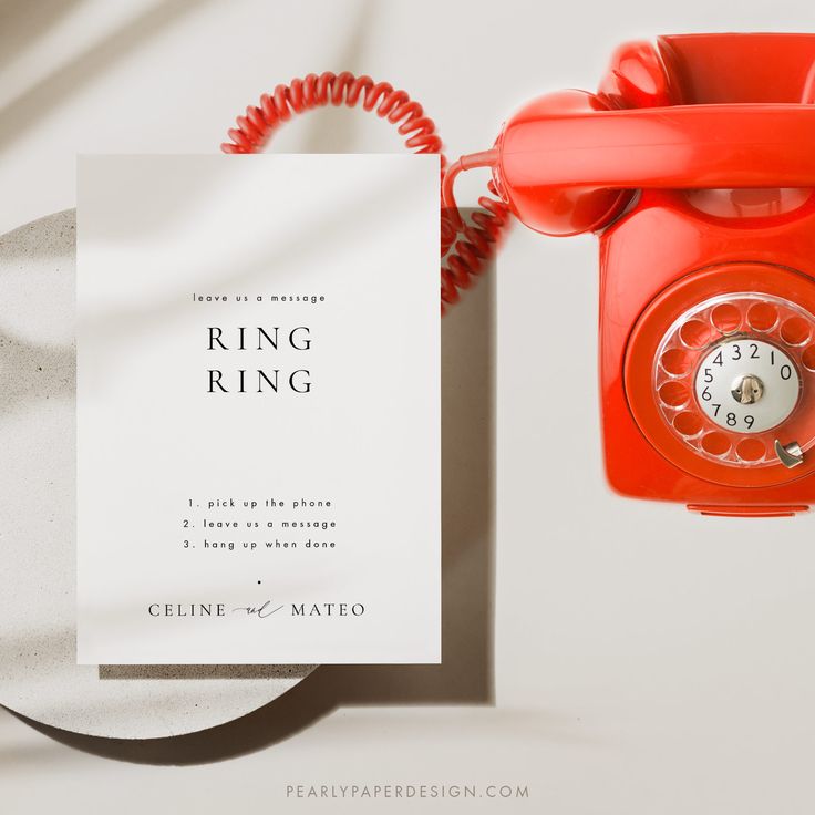 an orange phone next to a white card with the words ring ring on it and a red telephone