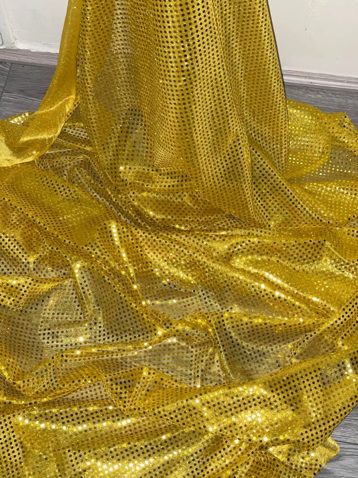 a yellow dress is sitting on the floor