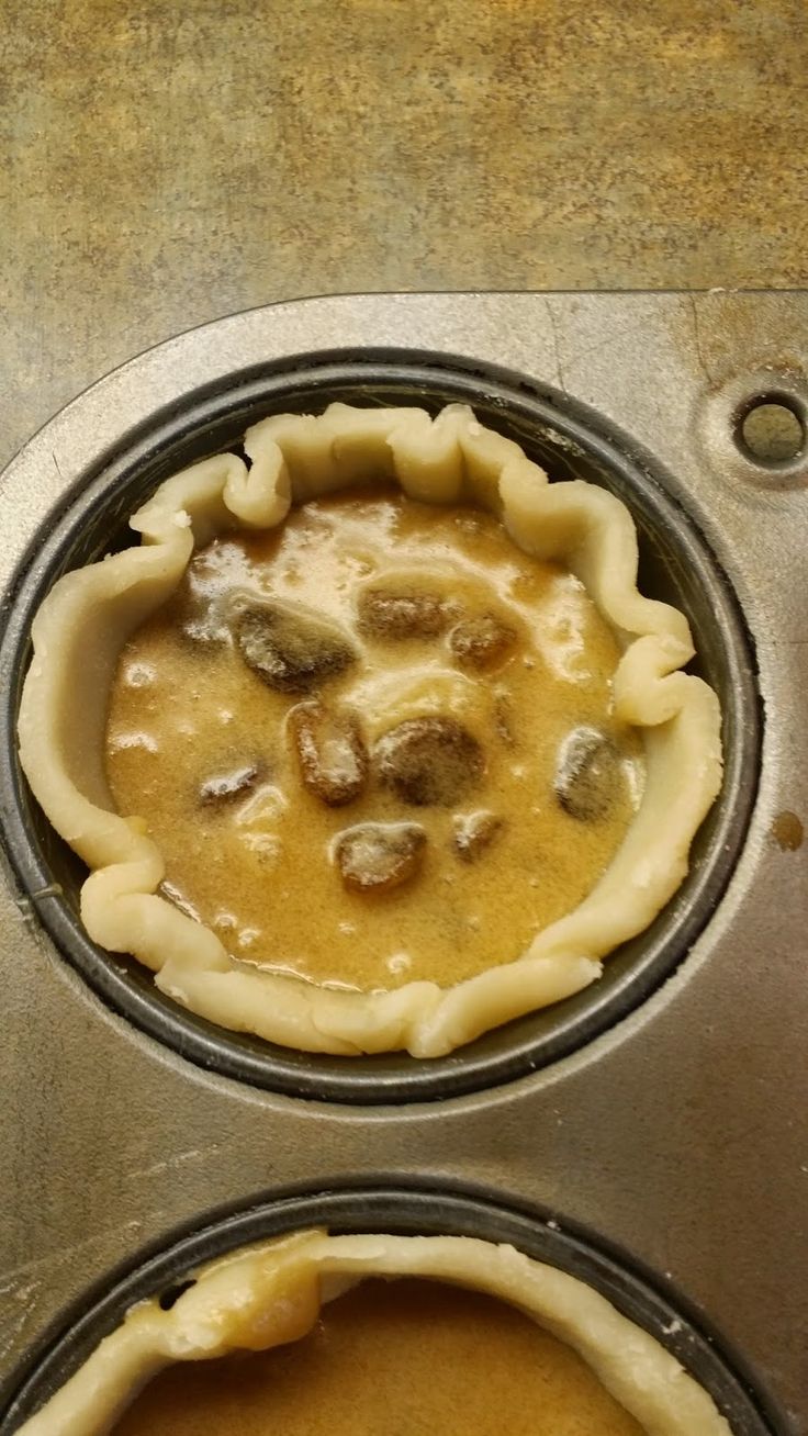 two pie pans filled with food sitting on top of a counter