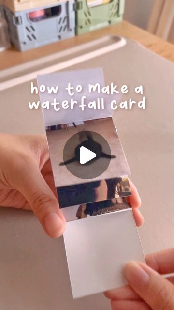 someone holding up a video card with the words how to make a water fall card