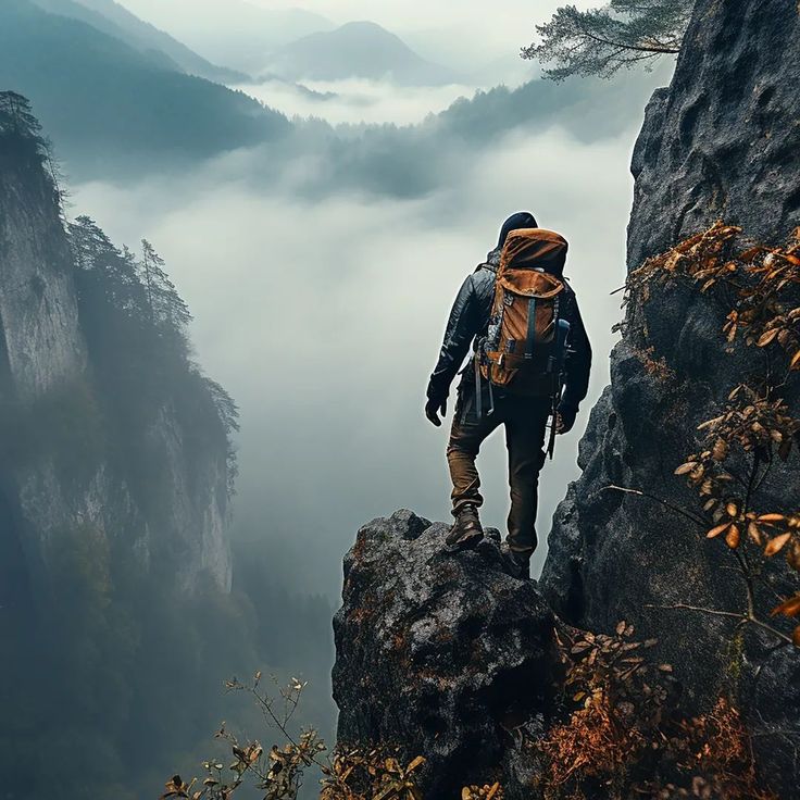 a man standing on top of a cliff