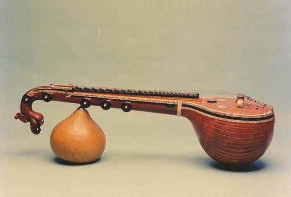 a wooden instrument sitting on top of a vase