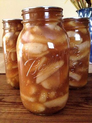 three jars filled with food sitting on top of a wooden table