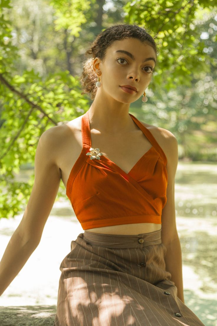 Add a pop of color to your wardrobe with this bright orange halter top that is sure to turn heads. Material | Dupioni Silk Blend Dry clean only Made in Los Angeles Items are made to order. Please allow 3-4 weeks for items to ship. Item shown is Size 6 Model is 5'9 Fitted Halter Neck Blouse, Fitted Orange Cropped Top, Fitted Cropped Orange Top, Chic Cropped Orange Top, Fitted Halter Neck Blouse For Summer, Sleeveless Orange Crop Top For Spring, Chic Fitted Orange Crop Top, Orange Fitted Crop Top For Spring, Fitted Orange Crop Top For Spring