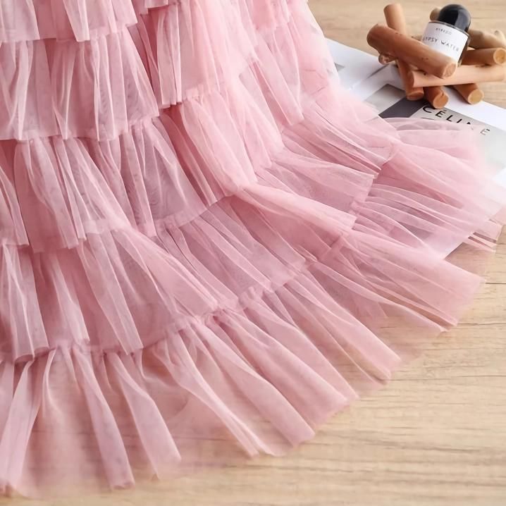 Discover the Charm of Elegance Step into a world of grace and style with our Elegant Spring/Summer Tulle Skirt. Designed for the modern woman who appreciates a blend of casual sophistication and timeless elegance, this skirt is perfect for a variety of occasions. Whether you're attending a casual gathering or dressing up for a more formal event, this skirt will elevate your wardrobe with its chic and versatile design. Product Features Material: High-quality polyester and voile blend for durability and a soft feel Style: Casual yet chic, with a solid pattern that pairs easily with any top Elasticity: Slight stretch to fit your body comfortably Season: Ideal for spring and summer wear Waistline: Empire cut to accentuate your figure Fit Type: Regular fit ensuring freedom of movement Silhouett Elegant Non-stretch Tiered Skirt, Elegant Non-stretch Tulle Skirt, Chic Non-stretch Tulle Skirt, Flowy Ruffle Midi Dress, Non-stretch Tiered Skirt For Party, Non-stretch Tiered Party Skirt, Flowy Summer Party Skirt, Long Pleated Skirt For Summer Party, Summer Party Tiered Maxi Skirt