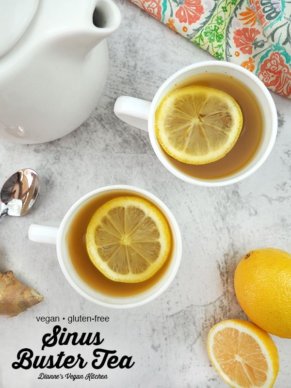 two cups of tea with lemons on the side