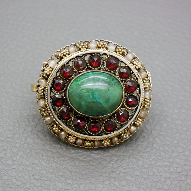 "A one of a kind gilt silver filigree brooch, set with blue / green Eilat stone and reg glass garnets. The brooch is a great quality traditional handwork of a Yemenite Israeli jeweler from 1950's - 1960's. Due to a hidden bale you may choose to wear this item as a brooch or as a pendant. You may choose to buy this item on its own or or with a matching 20 inches (50 cm) gold plated sterling silver rope chain, shown on the photos. The brooch will be shipped in a gift box. A lovely gift idea! The b Heirloom Style Collectible Jewelry With Brooch, Antique Cabochon Jewelry For Ceremonial Occasions, Victorian Filigree Jewelry For Ceremonial Occasions, Elegant Cabochon Jewelry For Ceremonial Occasions, Traditional Gold Jewelry With Cabochon, Ornate Pendant Brooch For Ceremonial Occasions, Traditional Filigree Jewelry, Ornate Pendant Jewelry, Antique Medallion Brooch Jewelry