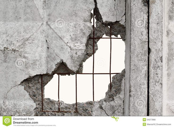 a broken window in the side of a concrete wall with bars on it and peeling paint