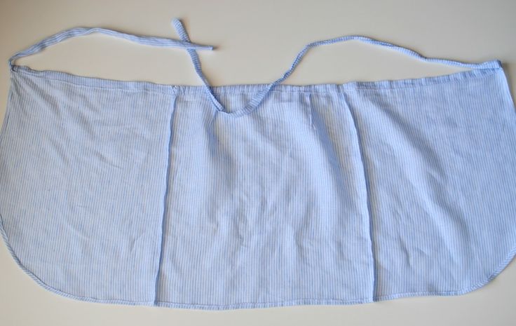 a blue and white striped apron on a table