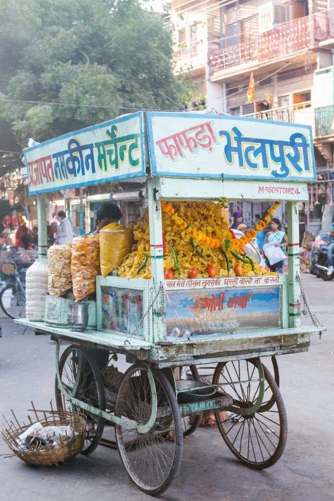 a cart with food on it in the middle of a street