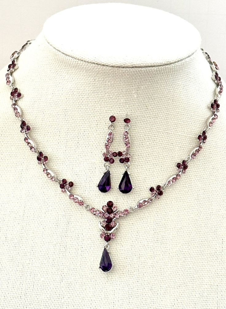 a necklace and earring set is shown on a mannequin