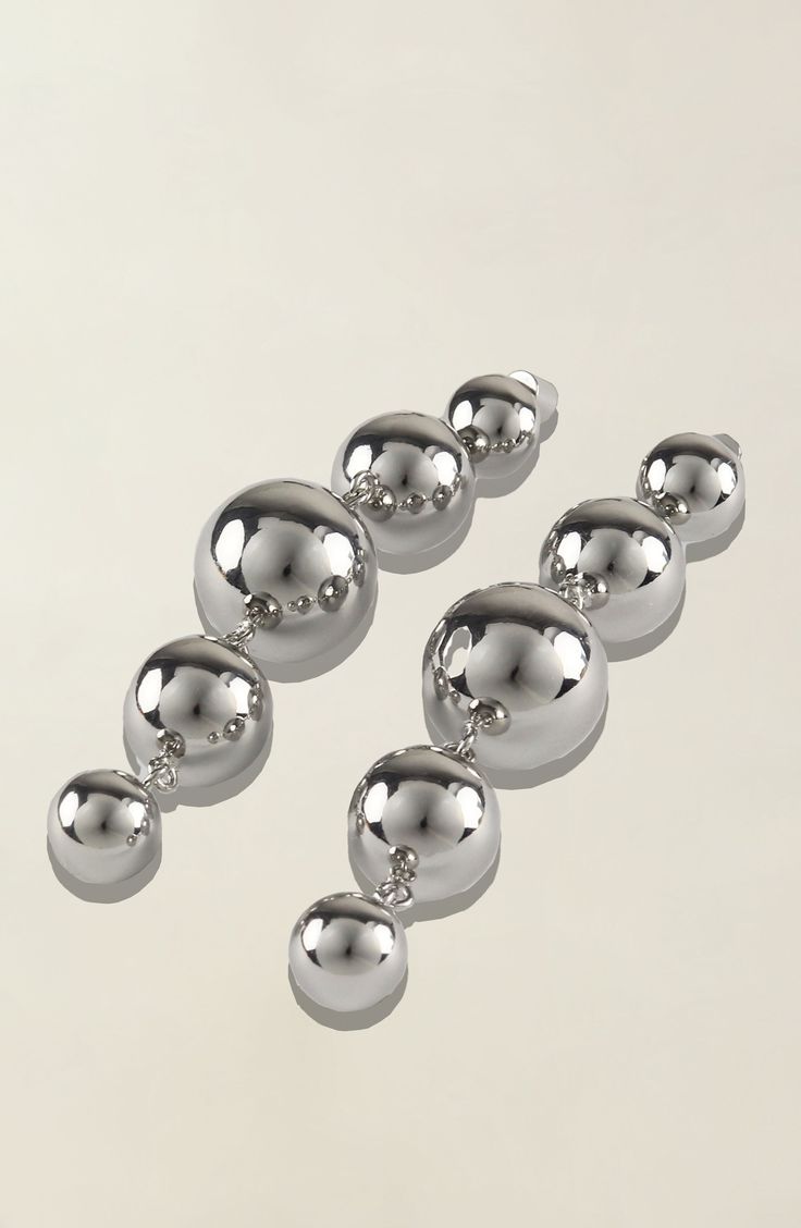 Elevate your style with our exquisite Multi-Sphere Shaped Drop Earrings, available in sleek silver plating. Crafted with meticulous attention to detail, these earrings are a testament to timeless elegance and contemporary charm. Due to hygiene-related reasons, this item may not be returned. Weight 38 g Elegant Silver Orb Earrings, Silver Orb-shaped Metal Jewelry, Silver Metal Linear Earrings, Modern Silver Linear Earrings For Party, Silver Sphere Metal Earrings, Silver Metal Linear Drop Earrings, Modern Silver Linear Drop Earrings, Modern Silver Chandelier Earrings For Party, Silver Metal Chandelier Earrings For Formal Occasions