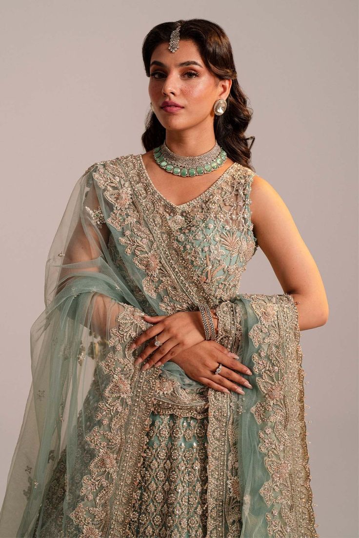 Pakistani Bridal Dress in Turquoise Lehenga Choli Style is embellished with zardosi, embroidery, sequins, motifs, and shimmering ornaments. Premium net fabric and perfect stitching make this Bridal Lehenga Choli an epitome of beauty and grace. Detailed Description: SKU: BS2483 Detailing: Embroidery, Motifs, Naqshi, Sequins, Dabka, Gota, Kora, Threads Color: Turquoise Blue Fabric: Organza, Net Design: Fully Embellished Dress with Embroidery Event: Bridal wear, Wedding Turquoise Lehenga, Blue Bridal Lehenga, Choli Style, Bridal Lehenga Pakistani, Pakistani Bridal Lehenga, Pakistani Bridal Dress, Dupatta Style, Zardosi Embroidery, Net Design