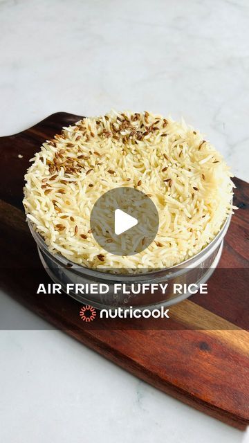 a video demonstrating how to make an air fried fluffy rice recipe on a cutting board