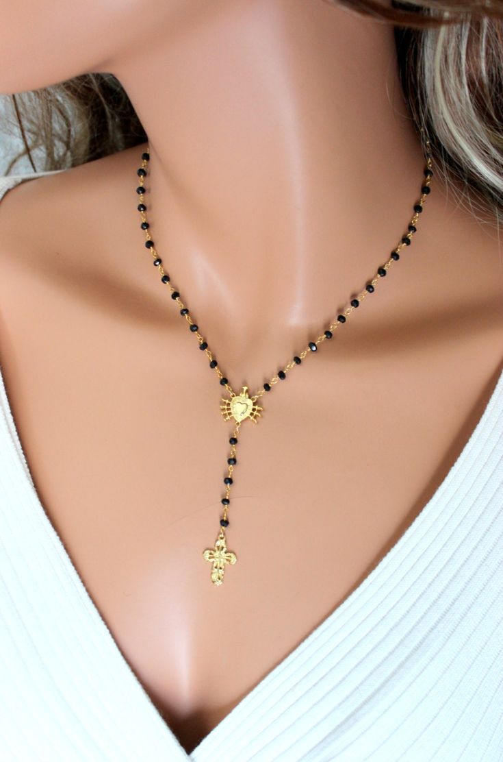 "This is a rosary style necklace made of 3mm black spinel gemstones on gold vermeil (24kt gold over 925 sterling silver). The beautiful center pendant is the Seven Sorrows of Mary Emblem in gold vermeil measuring 3/4\"x1/2\". Necklace may be ordered in a 16\", 18\" or 20\" length. This is the length around the neck only. There is a 2 3/4\" drop which includes a 3/4\" gold vermeil cross pendant. Necklace has a spring clasp closure in back. Comes nicely boxed, the perfect gift! Available in sterli Black Rosary Necklace, Catholic Jewelry Necklace, Gold Rosary Necklace, Black Rosary, 14kt Gold Jewelry, Rosary Style Necklace, Catholic Necklace, Black Beads Mangalsutra, Black Beads Mangalsutra Design