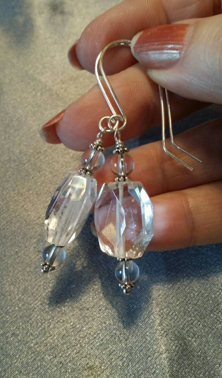 Three clear Quartz Crystal beads accented with sterling silver dangle from handcrafted sterling silver earwires -- and wow!  They sparkle! The larger bead is a faceted flat oval, and the two smaller ones are 6mm round beads.  Sterling silver daisy spacers provide accent.   Wonderful festive earrings for holiday or party wear -- enjoy them! Clear Crystal Dangle Jewelry, Clear Crystal Earrings As A Gift, Clear Crystal Earrings For Gift, Silver Czech Glass Jewelry With Matching Earrings, Crystal Earrings With Faceted Beads As Gift, Silver Teardrop Czech Glass Jewelry, Silver Faceted Crystal Jewelry, Clear Round Crystal Earrings With Ear Wire, Round Clear Crystal Earrings With Ear Wire