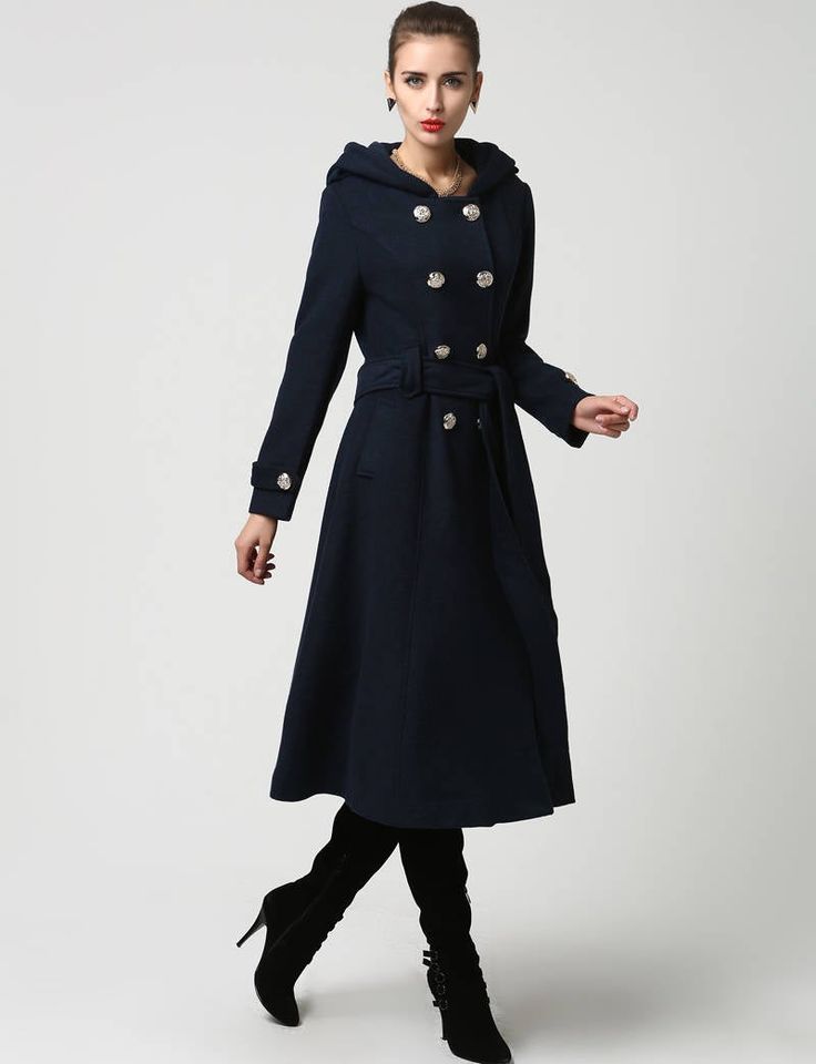 "This beautiful long wool coat features a double-breasted bodice and oversized silver buttons to create a distinct but classic military style. this winter coat features gorgeous navy blue wool, a polyester lining, and fun features like extra long sleeves, deep side pockets and back split vents. The self-tie belt makes it easy to accentuate your waist while the warm hood will stylishly shield you from the cold. DETAIL * 50% WOOL,50% POLYESTER * POLYESTER LINING * Epaulette with button * with warm Winter Double-breasted Wool Coat With Button Closure, Winter Wool Double-breasted Coat, Elegant Blue Wool Coat With Buttons, Double-breasted Wool Coat With Buttons For Winter, Double-breasted Wool Coat With Buttons For Spring, Spring Double-breasted Wool Coat With Buttons, Blue Double-breasted Wool Coat With Button Closure, Winter Long Pea Coat With Buttons, Winter Long Coat Peacoat With Double-breasted Buttons