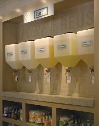 a display case filled with lots of different types of juices and drinks in plastic containers