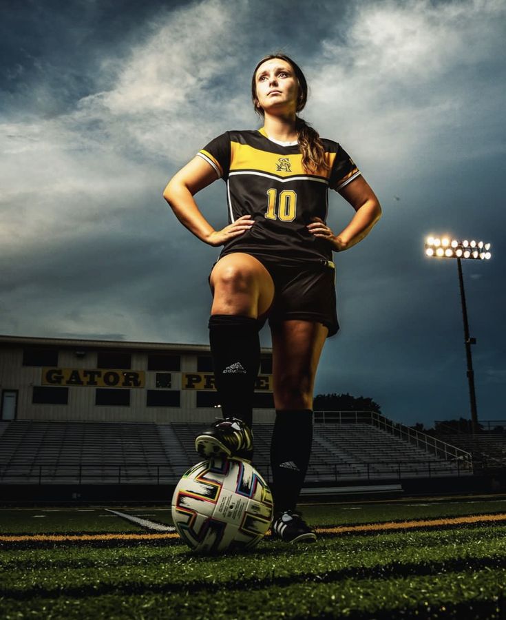 a female soccer player is posing for a photo