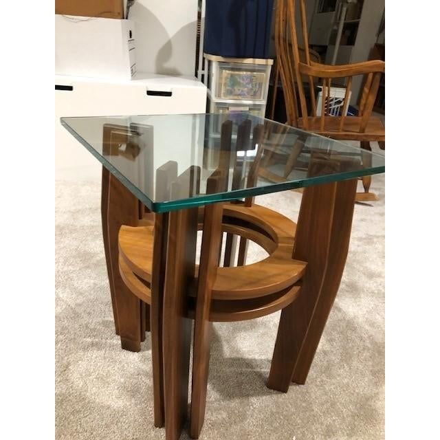 a glass table with chairs around it on carpeted flooring in front of boxes