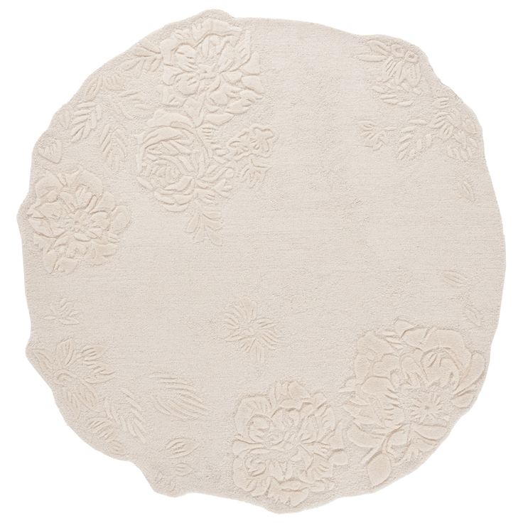 a white rug with flowers on the bottom and an oval shape in the middle,