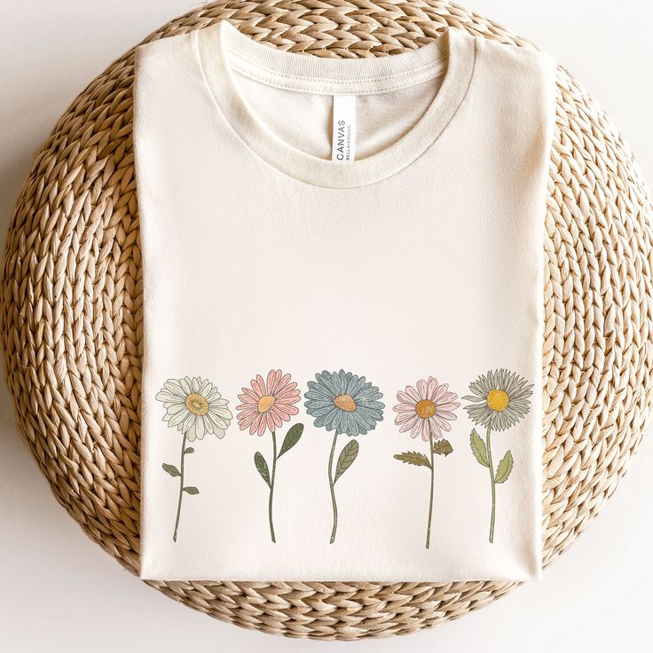 Are you looking for the Perfect Spring Shirt?  You found it! This Boho floral Wild Flower Daisy Shirt would be a great mothers day gift as well!  This is a unisex size T Shirt, please refer to the size chart pictured in the listing for choosing your perfect size. You will fall in love with this super soft tee with just the right amount of stretch! Its wildly comfortable and the unisex cut is flattering. It is one of our crowd favorites! It would make the perfect gift or grab it for yourself! It is sure you be your new favorite t shirt~ Our shirts are made with Direct to garment printing, not vinyl!  Which means your print will last longer and no peeling or cracking or fading! Yay!!  * Please read all details below. We want you to be completely happy with your purchase! 🌿 M A T E R I A L S Cotton Cottagecore Shirt With Floral Print, Spring Gift Shirt With Custom Print, Mother's Day Floral Print Cotton Shirt, Spring Gift Shirt With Relaxed Fit, Mother's Day Floral Cotton Top, Floral Print Flower-shaped Tops For Mother's Day, Floral Print Cotton Tops For Mother's Day, Cotton Floral Print Top For Mother's Day, Cotton Top With Floral Print For Mother's Day