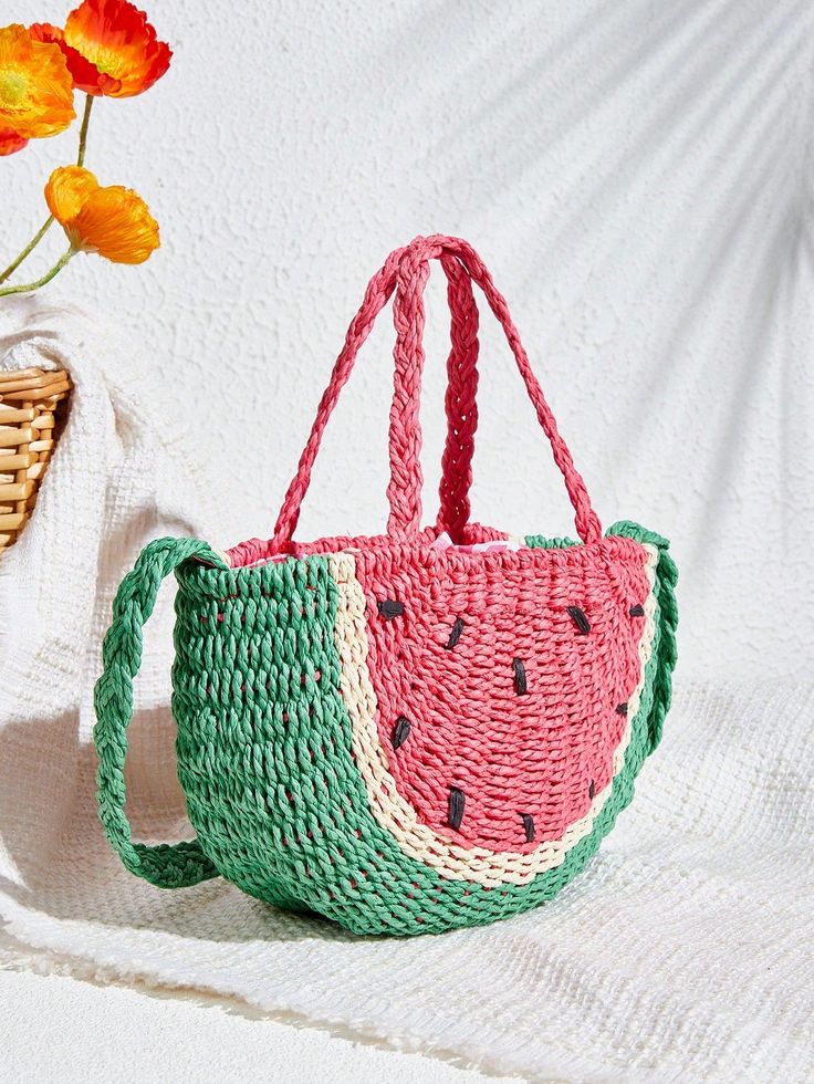 a watermelon bag sitting next to a basket with flowers in it