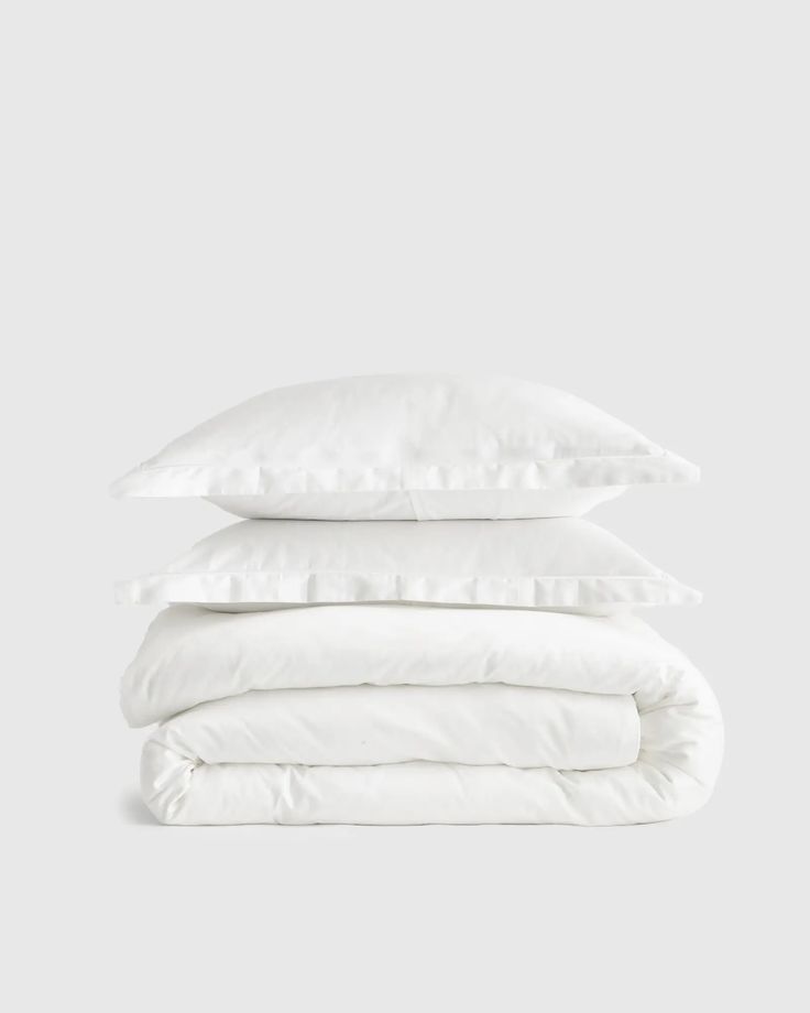 three white pillows stacked on top of each other