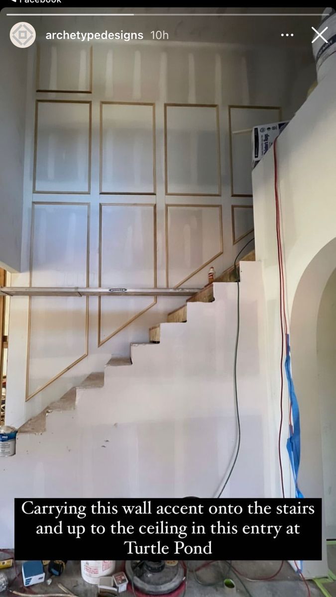 the stairs are being painted white and there is a quote on it that says, carrying this wall accent onto the stairs and up to the ceiling in this entry at turtle pond