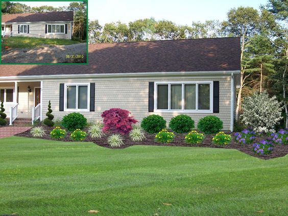 a house with landscaping in the front yard and side yard on the other side is shown