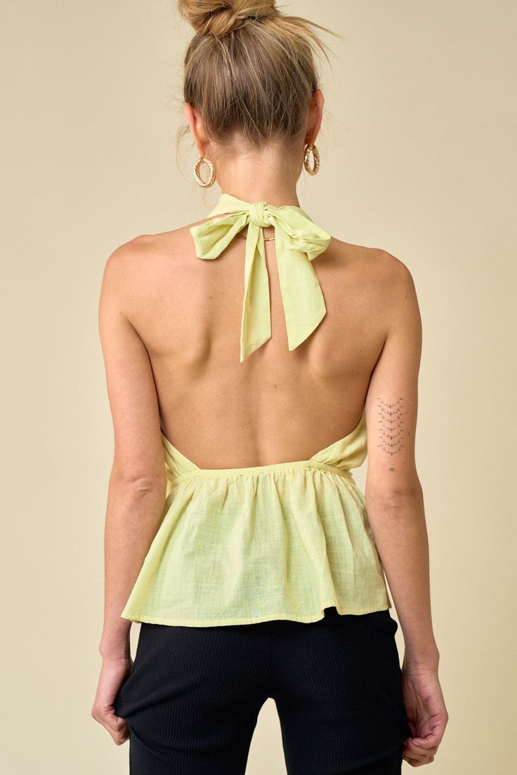 Add some fresh hues to your look for the new season with this halter top. Featuring a yellow floral linen material with twist details and a halter neck, it's perfect. Pair with white jeans and heels for an easy elevated look. Backless Summer Tops For Day Out, Backless Halter Top For Summer Brunch, Chic Summer Halter Top With Tie Back, Backless Summer Halter Top For Brunch, Tie Back Halter Top For Brunch, Green Backless Tops For Spring, Green Backless Top For Spring, Fitted Linen Halter Neck Top, Fitted Linen Halter Top