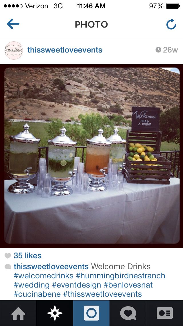 a table topped with glasses filled with drinks next to a sign that reads, photo